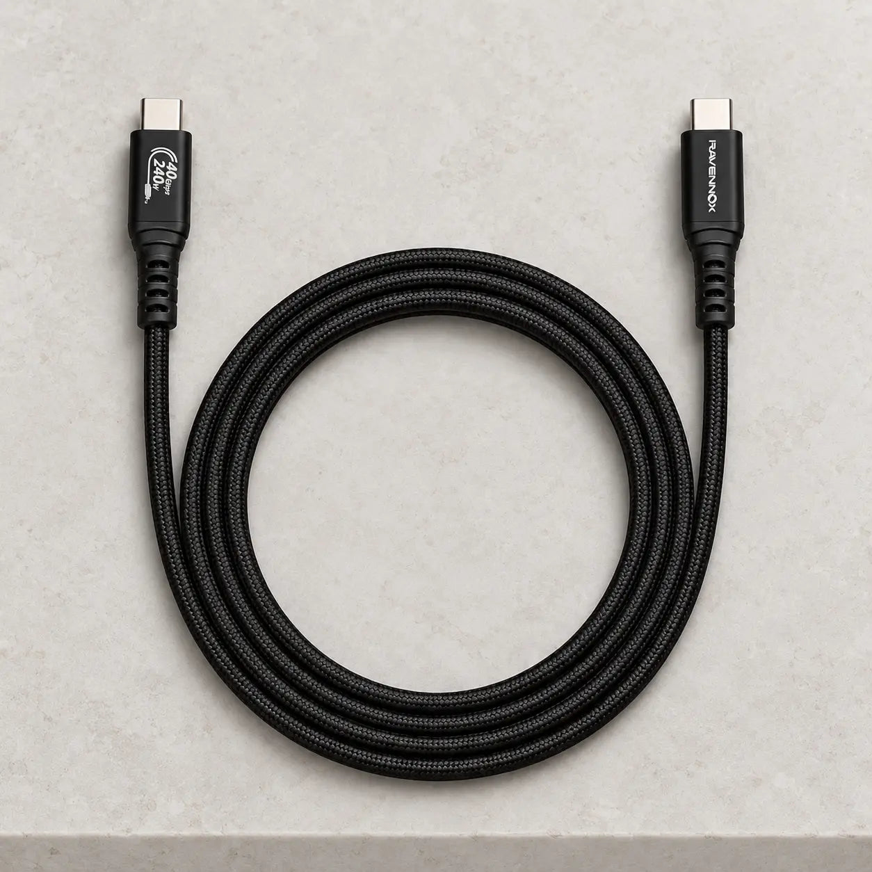 Coiled black Ravennox StormLink braided cable with both USB-C connectors visible.